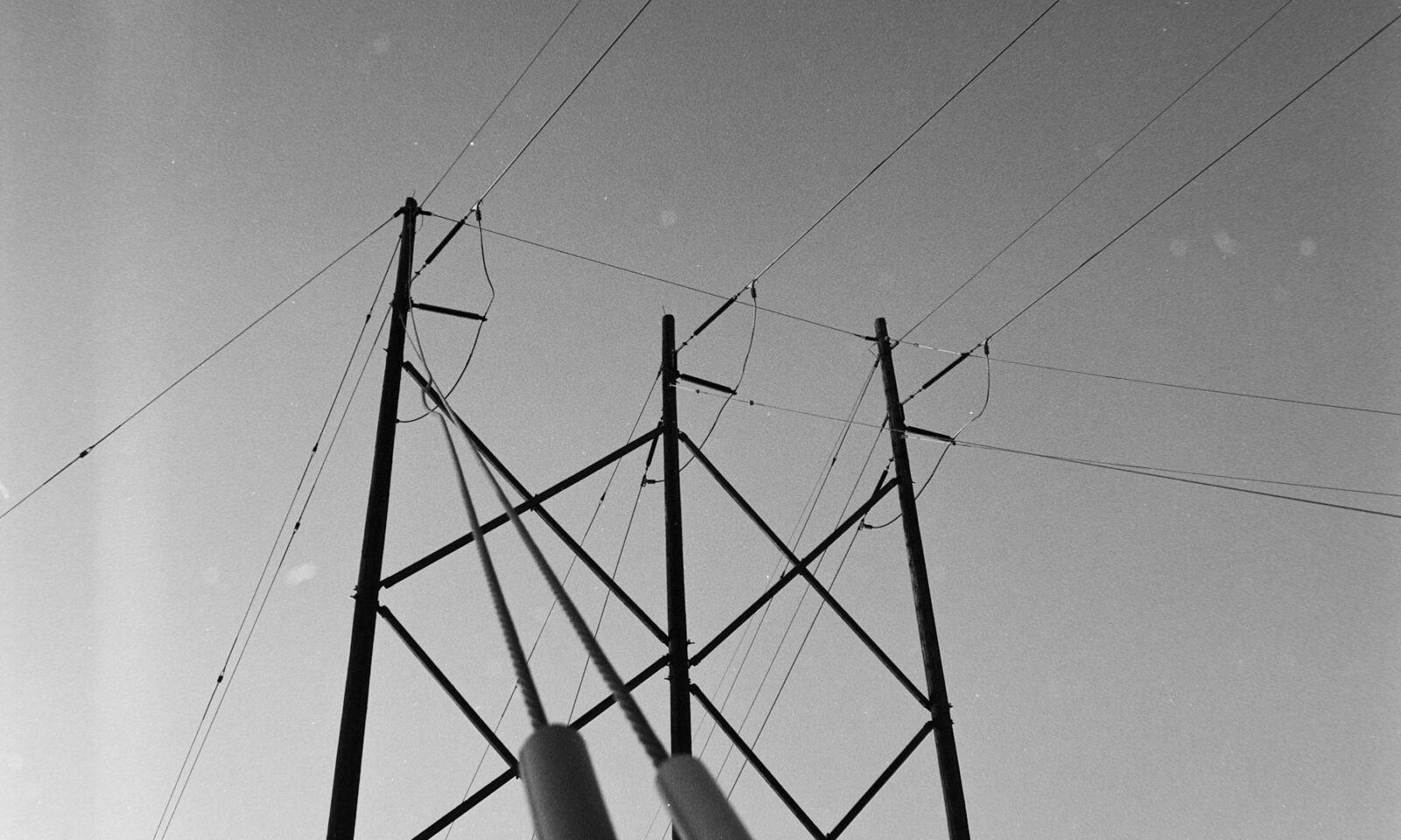 Electrical transmission tower and power lines against the sky