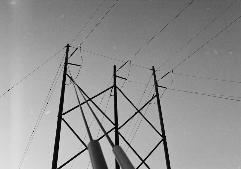 Electrical transmission tower and power lines against the sky