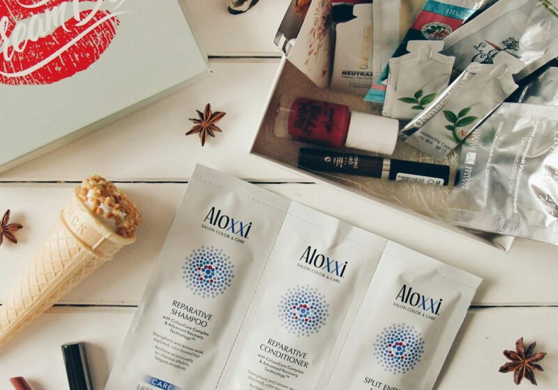 Beauty products arranged on a white wooden surface