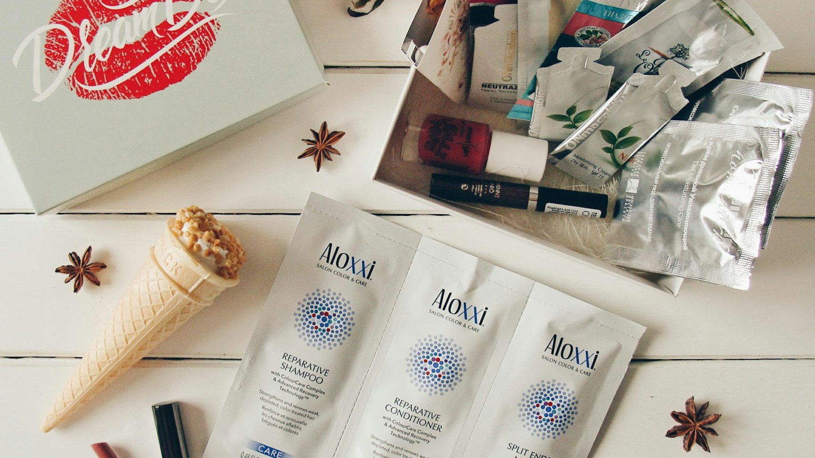 Beauty products arranged on a white wooden surface