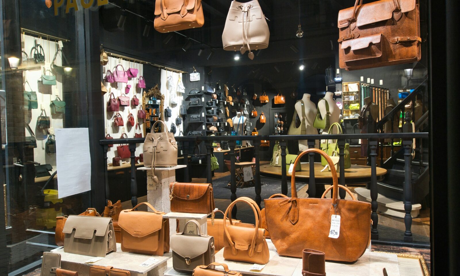 Leather handbags in a retail display illustrating fashion commerce and AI checkout