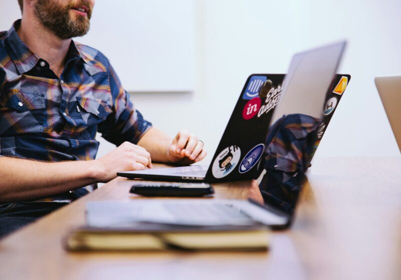 Product design team collaborating around a laptop
