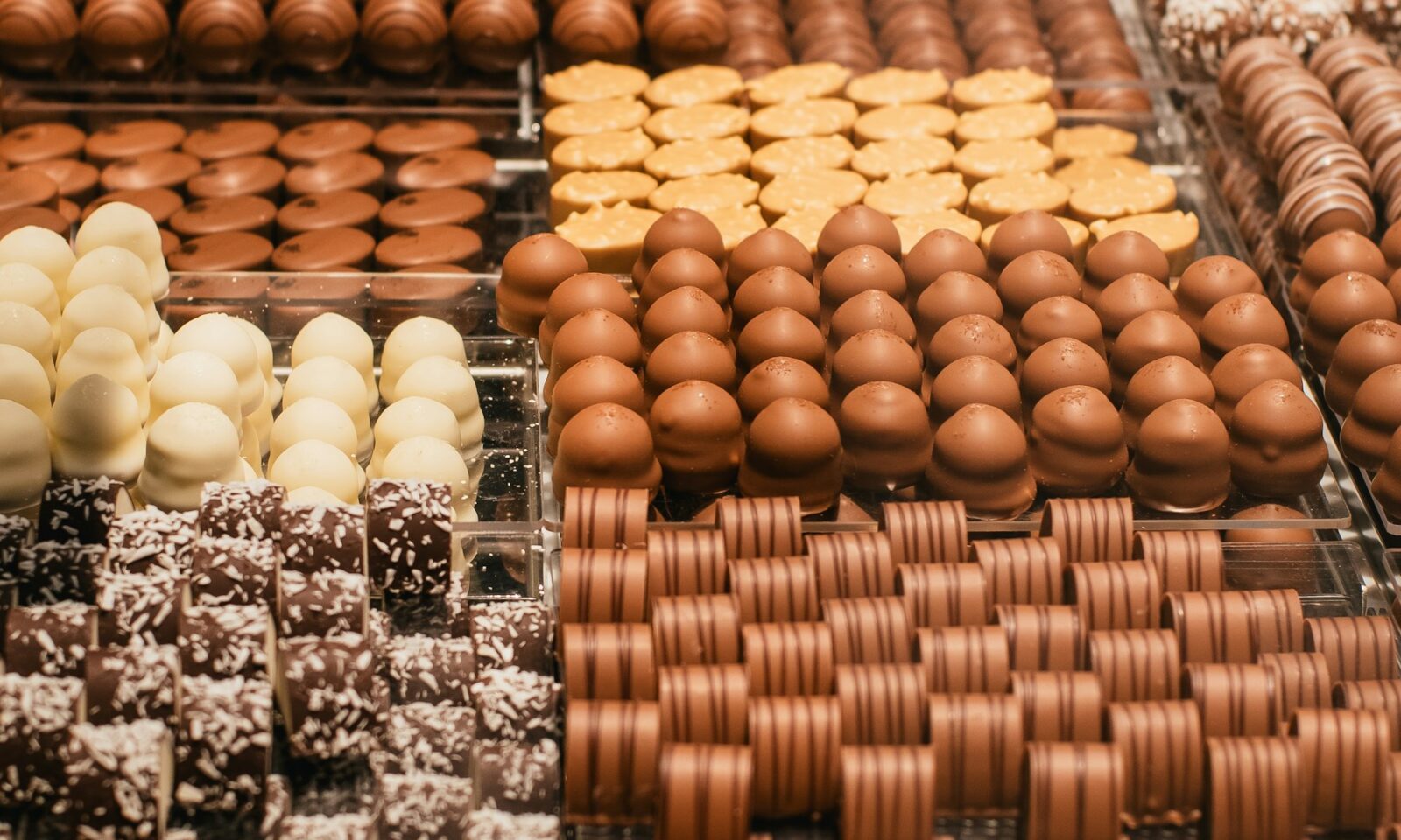 Rows of assorted chocolates arranged in a shop display