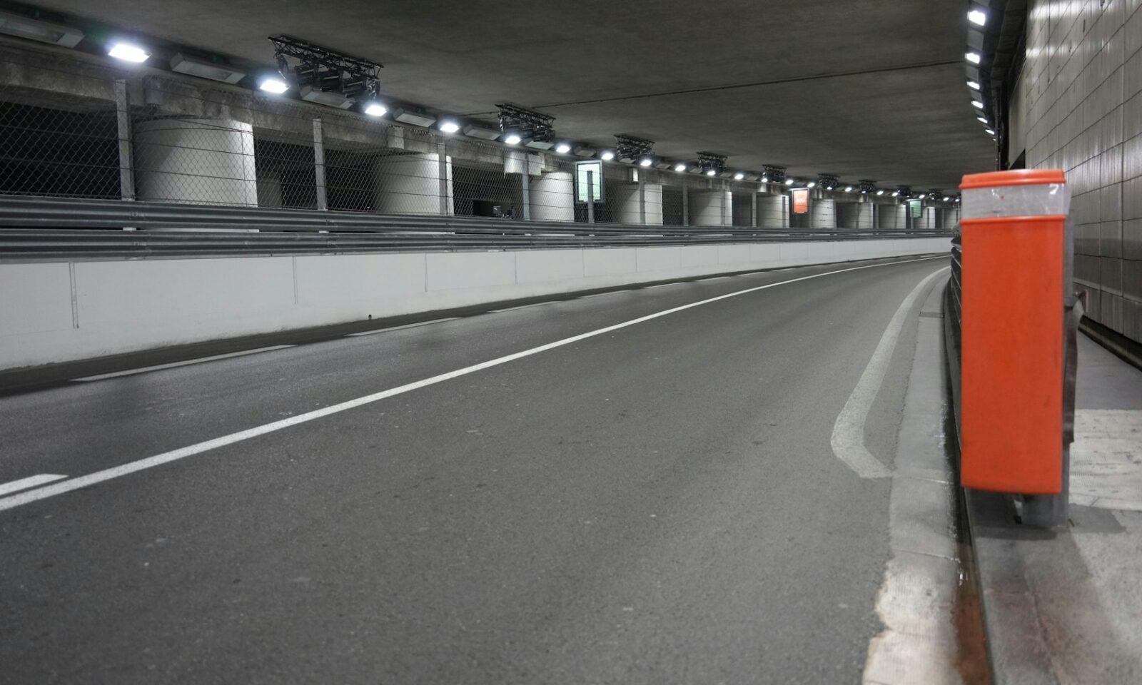 Empty modern road tunnel with bright overhead lights