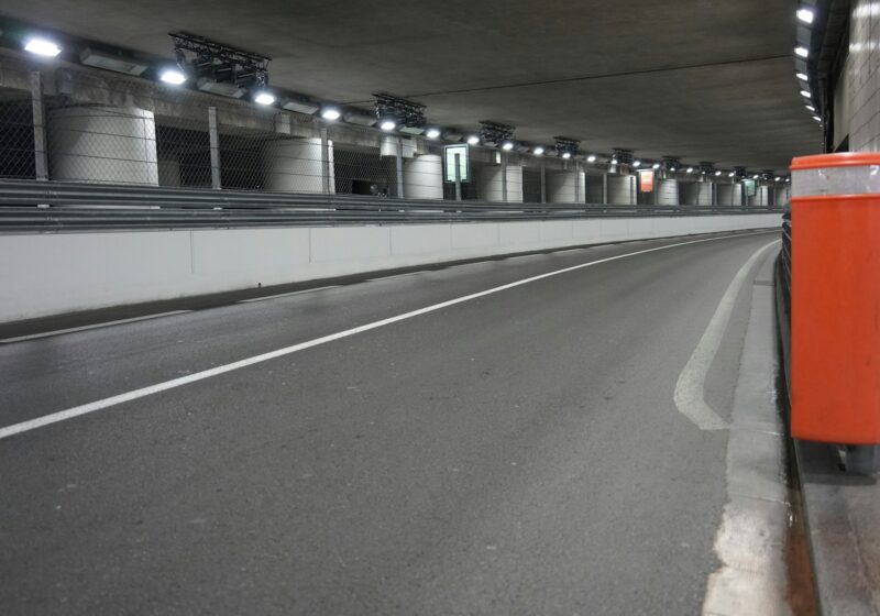 Empty modern road tunnel with bright overhead lights