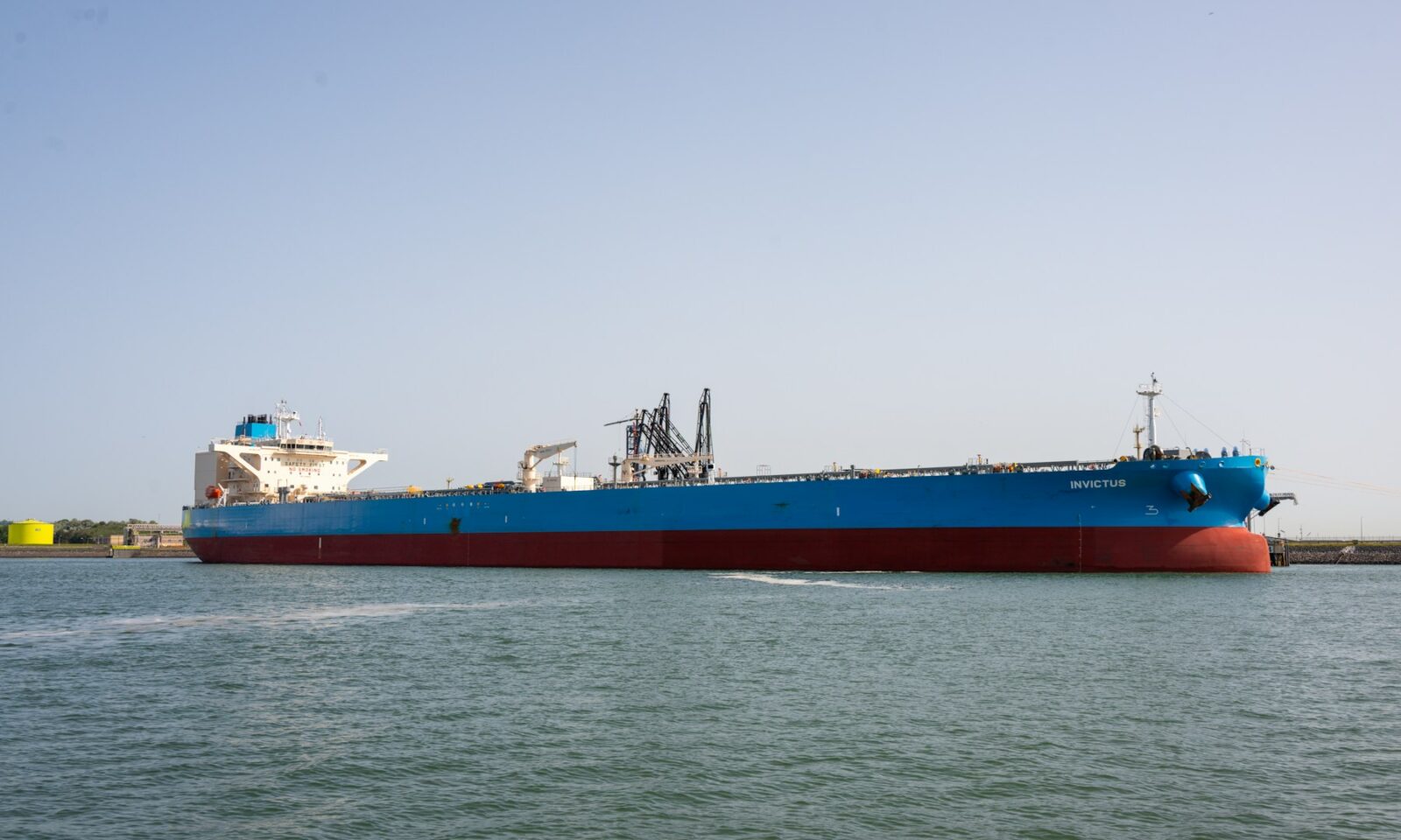 Large blue and red tanker in a harbor