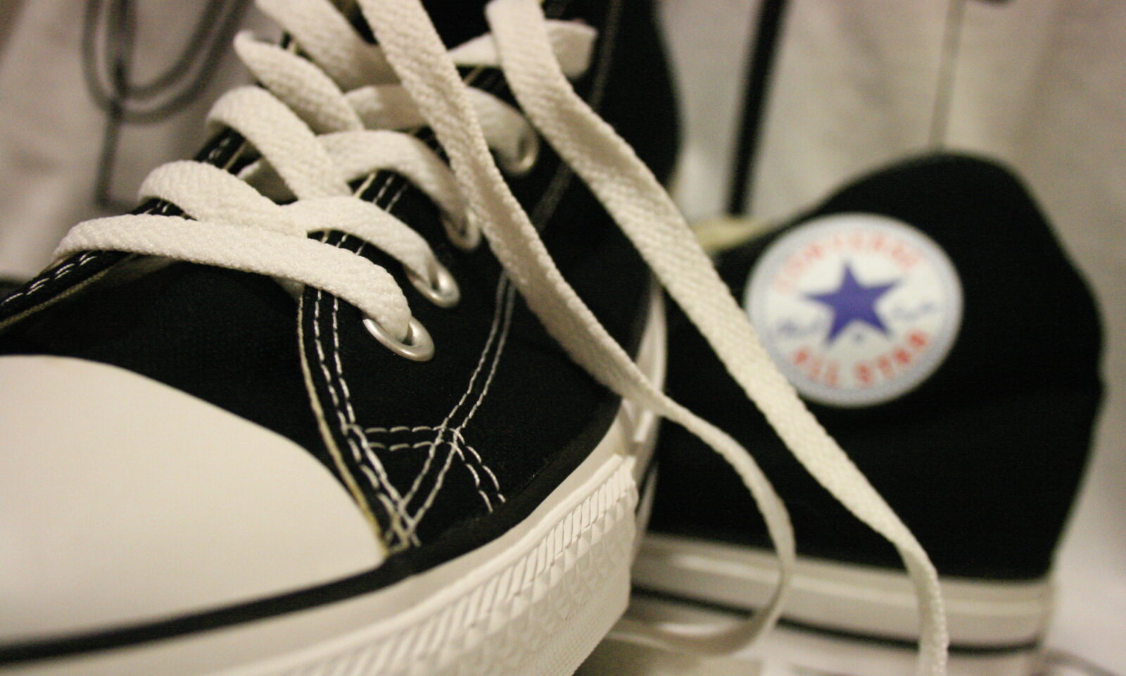 Close-up of black Converse Chuck Taylor sneakers with white laces