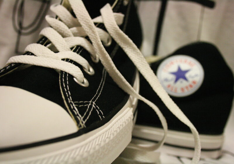 Close-up of black Converse Chuck Taylor sneakers with white laces