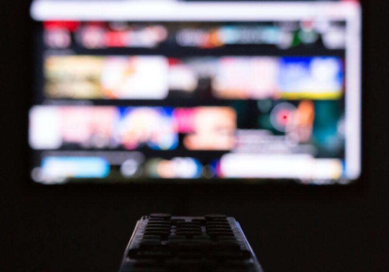 Remote control in front of a television screen