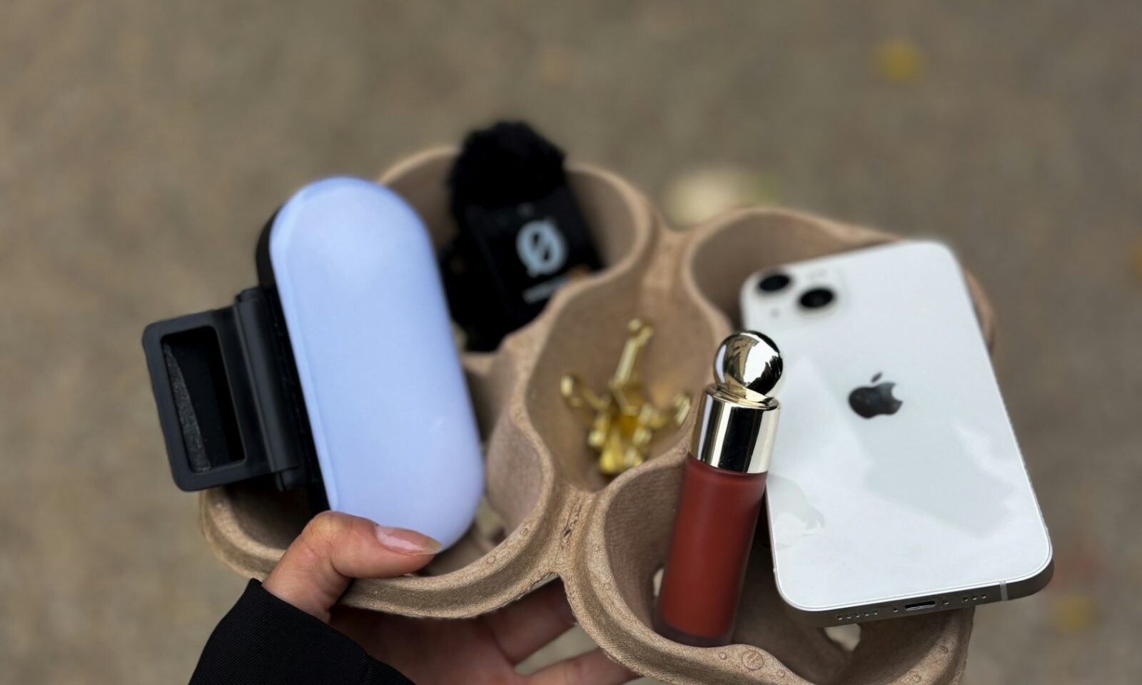 Smartphone, creator light and cosmetics arranged for social media content