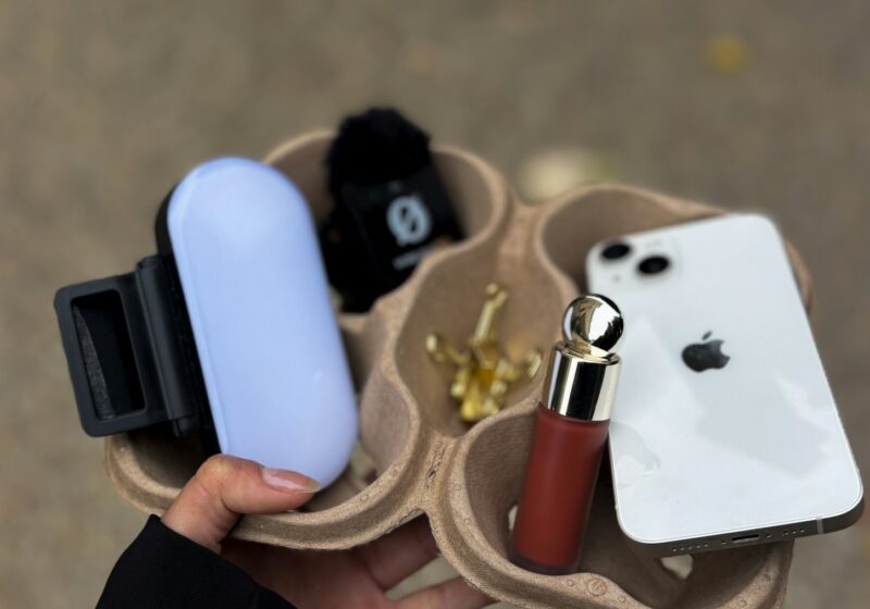 Smartphone, creator light and cosmetics arranged for social media content