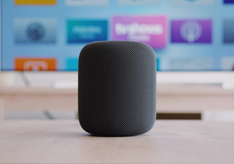 An original black Apple HomePod speaker on a table; not Apple HomeView
