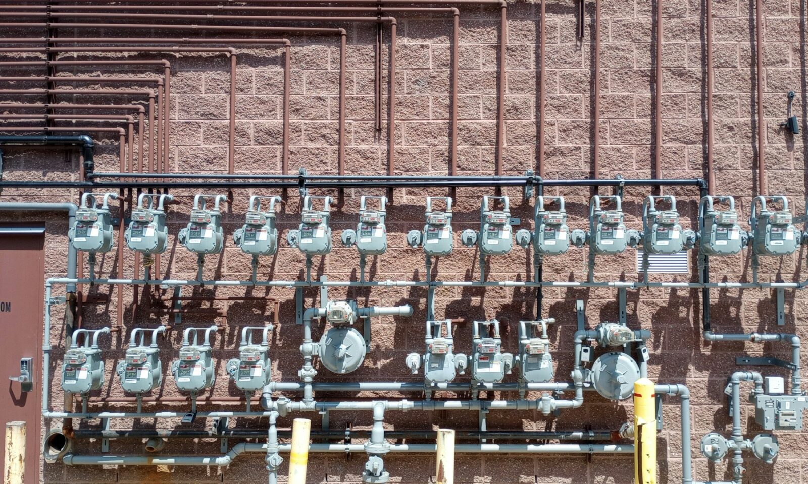 Rows of natural gas meters and pipes on an exterior wall in Dearborn, Michigan; not an EQT or Range facility