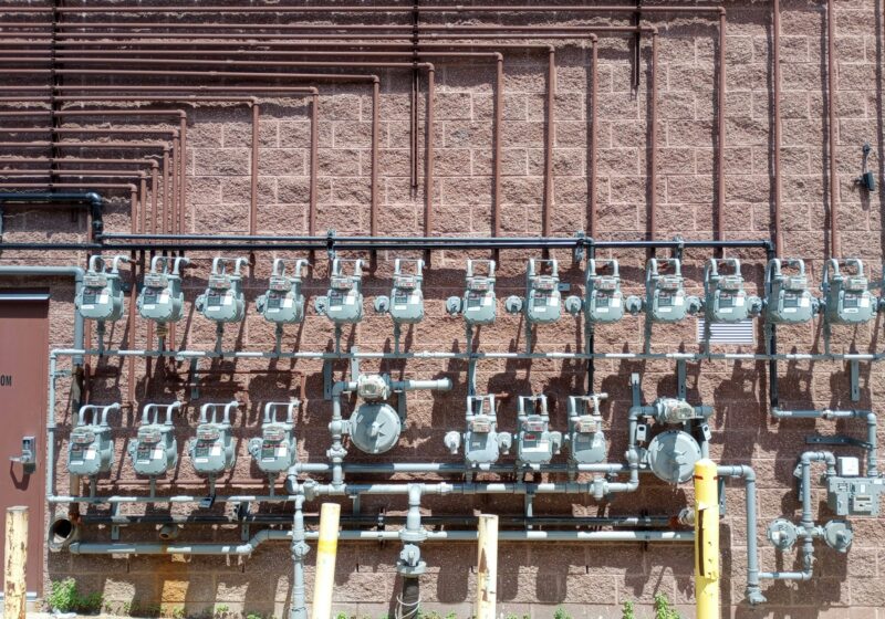 Rows of natural gas meters and pipes on an exterior wall in Dearborn, Michigan; not an EQT or Range facility
